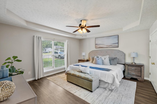 7616 Hudlow Ct, Fairview, TN 37062 - bedroom featuring a raised ceiling, a textured ceiling, dark wood-style floors, and a ceiling fan
