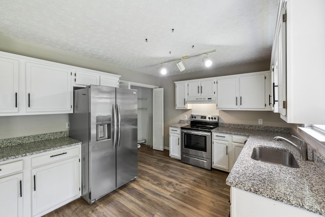 7616 Hudlow Ct, Fairview, TN 37062 - kitchen with stainless steel appliances, under cabinet range hood, white cabinetry, dark wood-style floors, and a textured ceiling