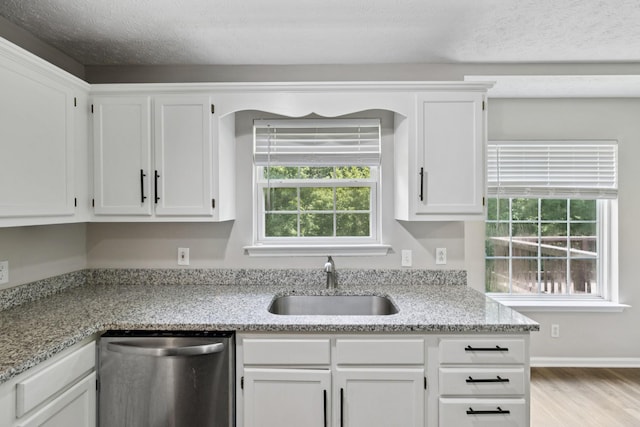 7616 Hudlow Ct, Fairview, TN 37062 - kitchen with dishwasher, wood finished floors, white cabinetry, and light stone countertops