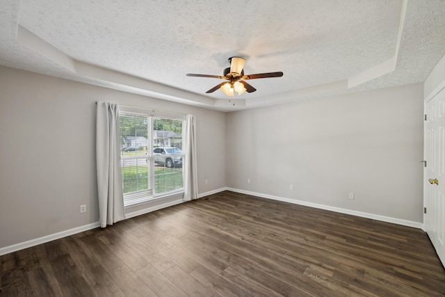 7616 Hudlow Ct, Fairview, TN 37062 - unfurnished room with a textured ceiling, a raised ceiling, dark wood-style flooring, and a ceiling fan
