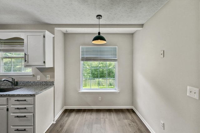 7616 Hudlow Ct, Fairview, TN 37062 - unfurnished dining area featuring dark wood finished floors and a textured ceiling