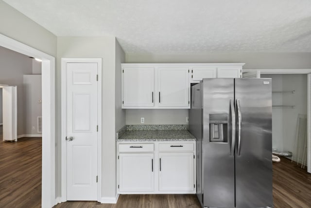 7616 Hudlow Ct, Fairview, TN 37062 - kitchen with stainless steel fridge with ice dispenser, white cabinetry, dark wood-style floors, light stone counters, and a textured ceiling