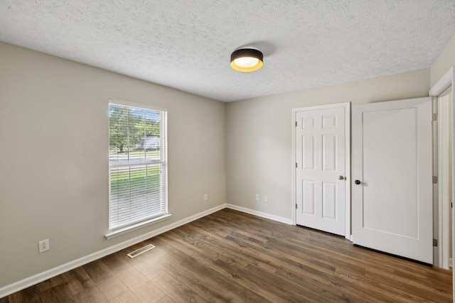 7616 Hudlow Ct, Fairview, TN 37062 - unfurnished bedroom with wood finished floors, a textured ceiling, and a closet