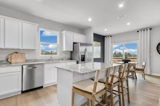 3294 Barrel Oak Pass, Columbia, TN 38401 - kitchen with appliances with stainless steel finishes, light wood finished floors, a center island, white cabinets, and recessed lighting