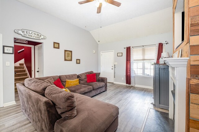8100 Cedar Forrest Rd, Lascassas, TN 37085 - living room with lofted ceiling, a ceiling fan, wood finished floors, stairway, and a fireplace with flush hearth