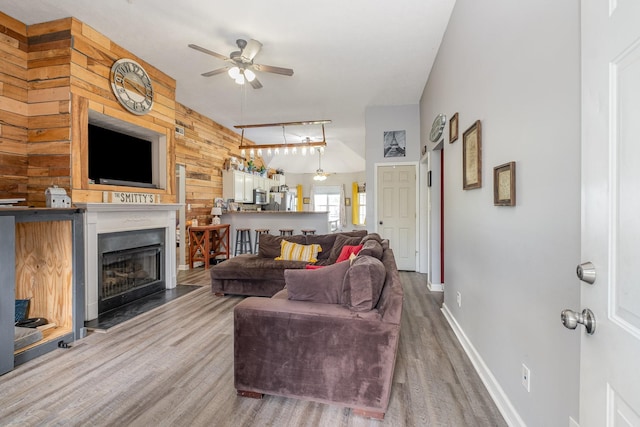 8100 Cedar Forrest Rd, Lascassas, TN 37085 - living area featuring a ceiling fan, wood finished floors, a fireplace, and wood walls