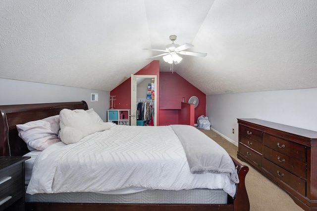 8100 Cedar Forrest Rd, Lascassas, TN 37085 - bedroom with light carpet, a walk in closet, lofted ceiling, a ceiling fan, and a textured ceiling