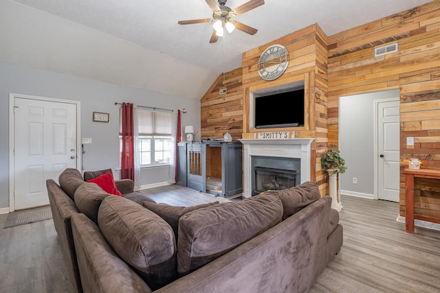 8100 Cedar Forrest Rd, Lascassas, TN 37085 - living area featuring wooden walls, ceiling fan, lofted ceiling, wood finished floors, and a fireplace