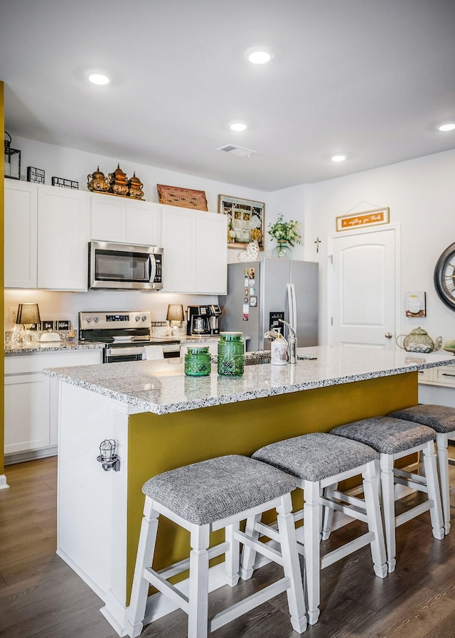 155 Nunally Dr, Baxter, TN 38544 - kitchen with stainless steel appliances, white cabinetry, a kitchen island with sink, dark wood finished floors, and recessed lighting
