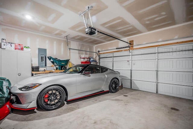 155 Nunally Dr, Baxter, TN 38544 - garage featuring electric panel and a garage door opener