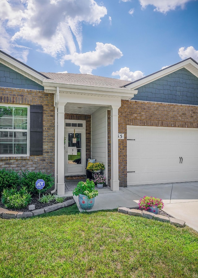 155 Nunally Dr, Baxter, TN 38544 - view of front facade featuring brick siding, driveway, an attached garage, and a front lawn
