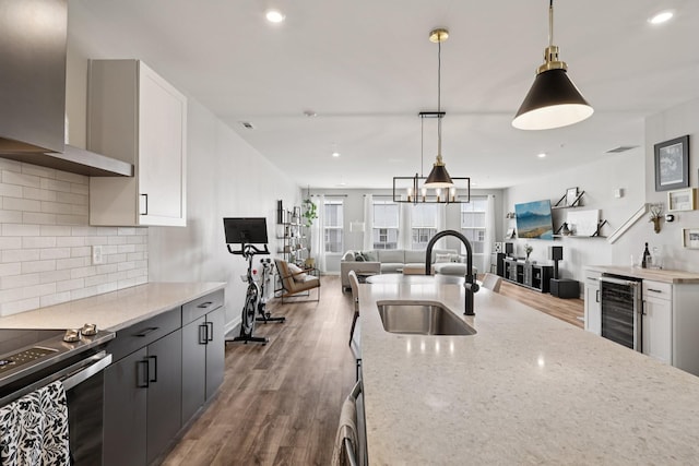 2006 Edison Park Ln, Nashville, TN 37209 - kitchen with beverage cooler, open floor plan, range with electric cooktop, decorative backsplash, and wall chimney exhaust hood