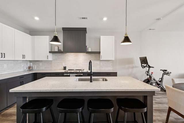 2006 Edison Park Ln, Nashville, TN 37209 - kitchen featuring light stone countertops, light wood-style flooring, decorative backsplash, and recessed lighting