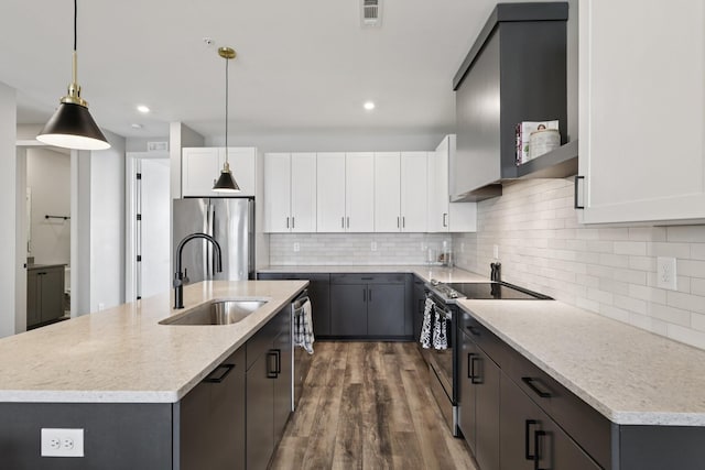 2006 Edison Park Ln, Nashville, TN 37209 - kitchen featuring stainless steel appliances, wood finished floors, tasteful backsplash, hanging light fixtures, and recessed lighting