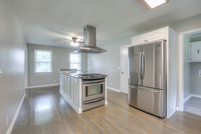1213 N Graycroft Ave, Madison, TN 37115 - kitchen featuring stainless steel appliances, island exhaust hood, white cabinets, ceiling fan, and light wood finished floors