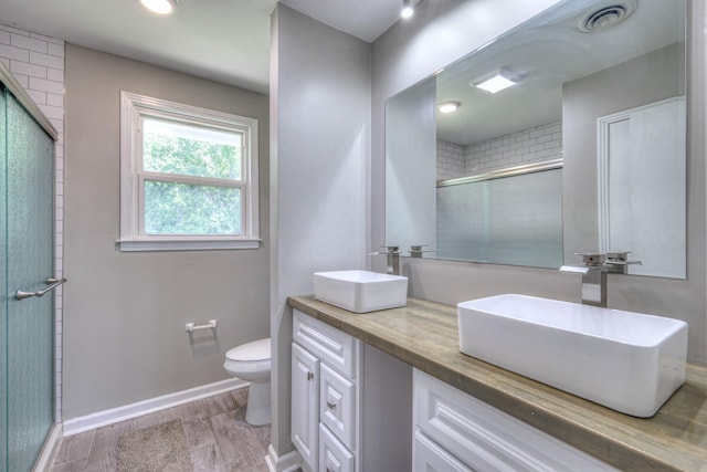 1213 N Graycroft Ave, Madison, TN 37115 - bathroom featuring double vanity, a tile shower, and wood finished floors