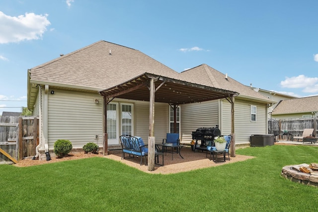 1319 Knoll Ln, Lebanon, TN 37087 - back of property with an outdoor fire pit, a patio area, and a shingled roof