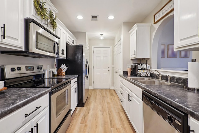 1319 Knoll Ln, Lebanon, TN 37087 - kitchen with appliances with stainless steel finishes, dark countertops, white cabinets, and recessed lighting