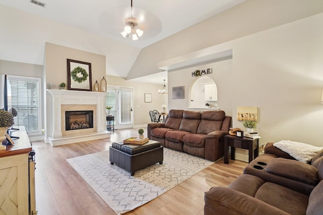 1319 Knoll Ln, Lebanon, TN 37087 - living area featuring ceiling fan, plenty of natural light, light wood-style flooring, lofted ceiling, and a fireplace