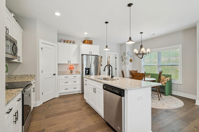 26 Sycamore Rdg W, Burns, TN 37029 - kitchen featuring appliances with stainless steel finishes, dark wood finished floors, a chandelier, white cabinetry, and pendant lighting