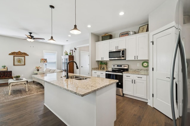 26 Sycamore Rdg W, Burns, TN 37029 - kitchen with stainless steel appliances, dark wood-type flooring, white cabinetry, ceiling fan, and decorative light fixtures