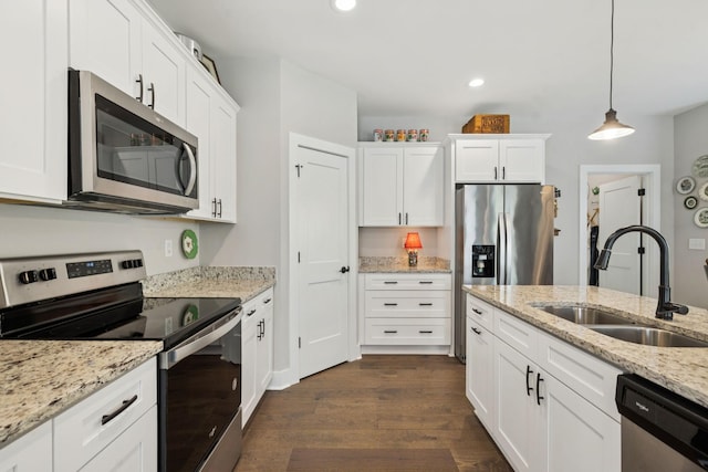 26 Sycamore Rdg W, Burns, TN 37029 - kitchen featuring stainless steel appliances, dark wood-style flooring, white cabinets, hanging light fixtures, and recessed lighting