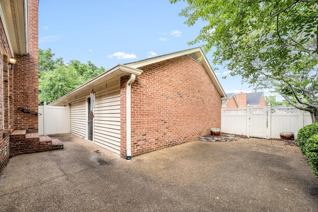 1436 Cheshire Pl, Murfreesboro, TN 37129 - view of home's exterior featuring a patio, a gate, and brick siding
