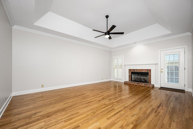 1436 Cheshire Pl, Murfreesboro, TN 37129 - unfurnished living room featuring a tray ceiling, plenty of natural light, a ceiling fan, wood finished floors, and crown molding