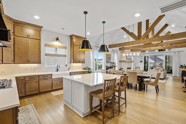 5831 Branta Dr, Franklin, TN 37064 - kitchen with tasteful backsplash, a center island, light countertops, a breakfast bar area, and pendant lighting