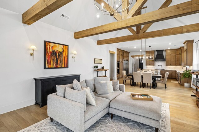 5831 Branta Dr, Franklin, TN 37064 - living area featuring a chandelier, beamed ceiling, light wood-style flooring, recessed lighting, and high vaulted ceiling