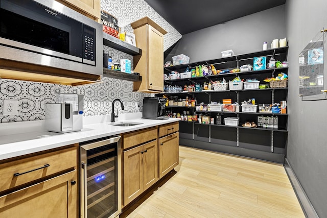 5831 Branta Dr, Franklin, TN 37064 - bar area featuring beverage cooler, stainless steel microwave, light wood-type flooring, and tasteful backsplash