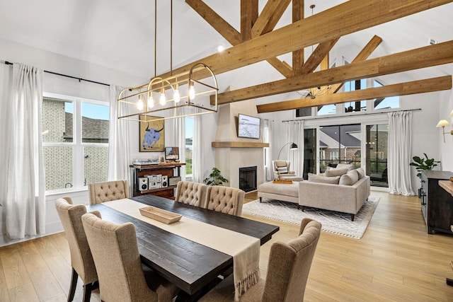 5831 Branta Dr, Franklin, TN 37064 - dining space featuring a chandelier, light wood finished floors, a fireplace, and high vaulted ceiling