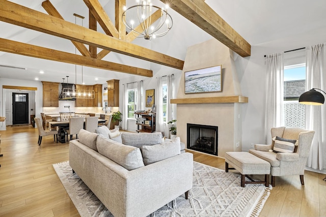 5831 Branta Dr, Franklin, TN 37064 - living area featuring beam ceiling, a chandelier, high vaulted ceiling, a fireplace, and light wood-style flooring