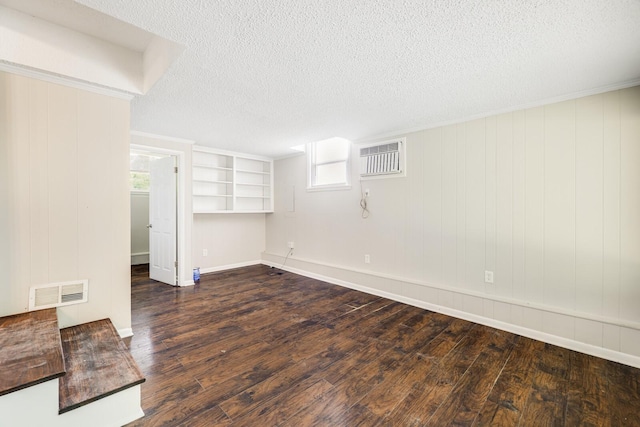 2010 Olympia Pl, Murfreesboro, TN 37130 - spare room featuring dark wood-style flooring, a wall mounted air conditioner, and a textured ceiling