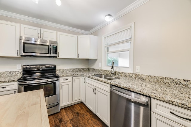 2010 Olympia Pl, Murfreesboro, TN 37130 - kitchen featuring stainless steel appliances, ornamental molding, white cabinets, light stone countertops, and dark wood finished floors