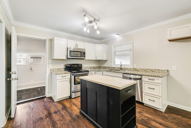 2010 Olympia Pl, Murfreesboro, TN 37130 - kitchen featuring stainless steel appliances, white cabinetry, ornamental molding, a kitchen island, and dark wood finished floors
