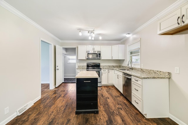 2010 Olympia Pl, Murfreesboro, TN 37130 - kitchen featuring stainless steel appliances, a center island, light stone counters, white cabinetry, and dark wood-type flooring