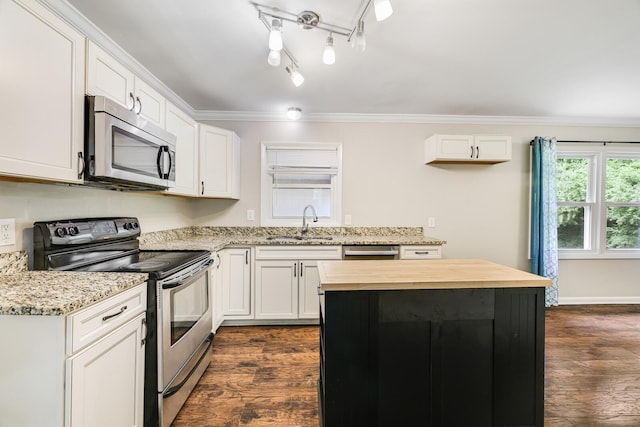 2010 Olympia Pl, Murfreesboro, TN 37130 - kitchen featuring stainless steel appliances, butcher block counters, ornamental molding, dark wood-style floors, and white cabinets