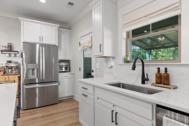 8408 Morin Rd, Chattanooga, TN 37421 - kitchen with stainless steel appliances, white cabinets, tasteful backsplash, light stone counters, and crown molding