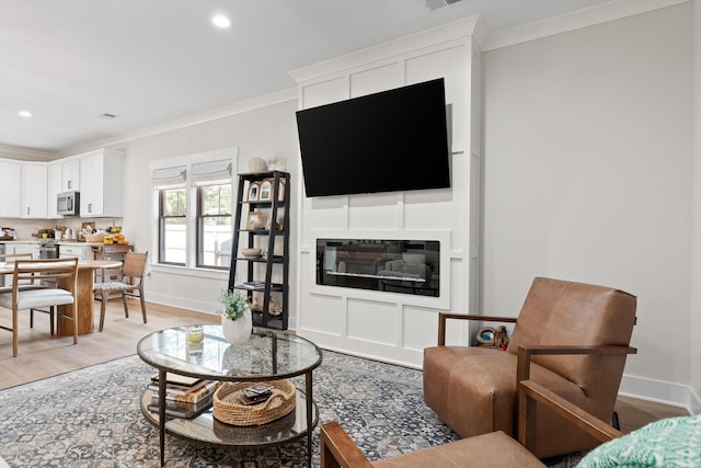 8408 Morin Rd, Chattanooga, TN 37421 - living room featuring ornamental molding, light wood-type flooring, recessed lighting, and a glass covered fireplace