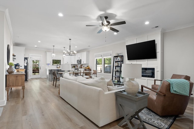 8408 Morin Rd, Chattanooga, TN 37421 - living area with ceiling fan, recessed lighting, light wood-style flooring, ornamental molding, and a chandelier