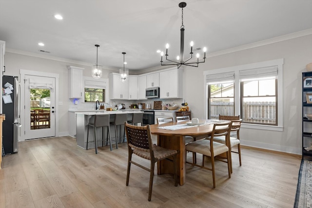8408 Morin Rd, Chattanooga, TN 37421 - dining room with a chandelier, crown molding, light wood-style flooring, and recessed lighting