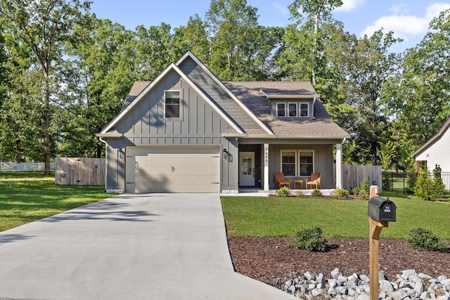 8408 Morin Rd, Chattanooga, TN 37421 - view of front of house featuring covered porch, driveway, board and batten siding, and a garage