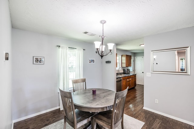 112 Ray Ave, Old Hickory, TN 37138 - dining room with dark wood finished floors, a chandelier, and a textured ceiling