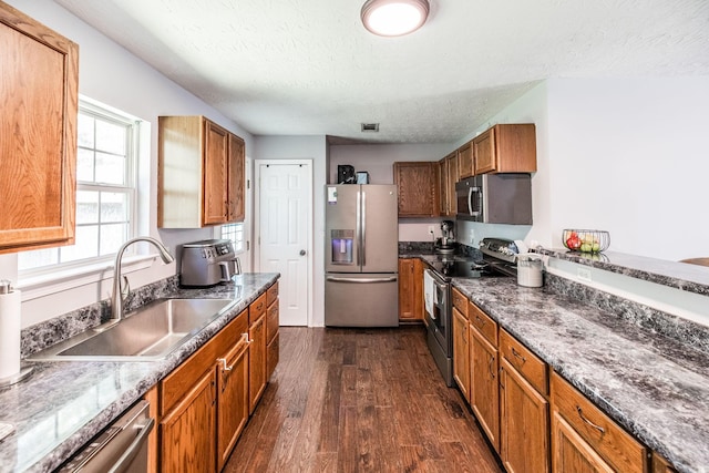 112 Ray Ave, Old Hickory, TN 37138 - kitchen with stainless steel appliances, a textured ceiling, dark wood-style floors, and brown cabinets