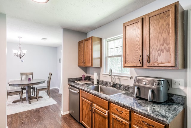 112 Ray Ave, Old Hickory, TN 37138 - kitchen with dishwasher, dark countertops, dark wood-style floors, brown cabinets, and a chandelier