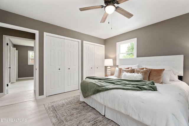 588 Meadowbrook Dr, Mcminnville, TN 37110 - bedroom featuring multiple closets, light wood-style floors, and a ceiling fan