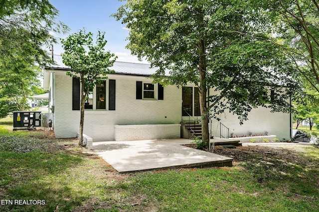 588 Meadowbrook Dr, Mcminnville, TN 37110 - view of front of property with brick siding, a patio area, and a metal roof