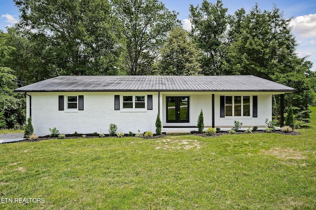 588 Meadowbrook Dr, Mcminnville, TN 37110 - view of front facade featuring brick siding, a metal roof, and a front yard