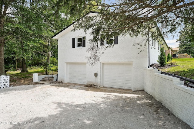 588 Meadowbrook Dr, Mcminnville, TN 37110 - view of home's exterior with a garage, brick siding, and driveway
